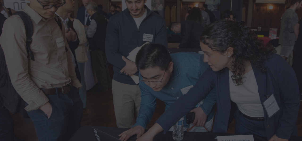 Attendees gather around a laptop at an IBM Quantum table at the 2025 Chicago Quantum Recruiting Forum.