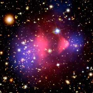Picture of the cosmos. Bright pink, purple, and yellow dots of light on a black space background. 