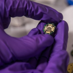A student holds experimental quantum technology in the laboratory of Prof. David Awschalom at the University of Chicago.