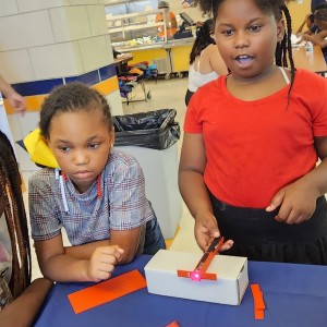 Children playing with a Wonders of Quantum Physics laser kit