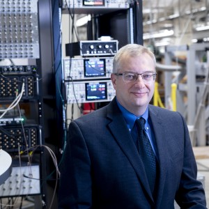 Michael Manfra standing in front of lab equipment.