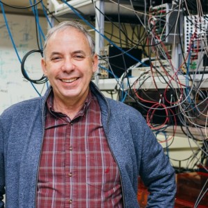 Mark Saffman standing and smiling in a lab setting.
