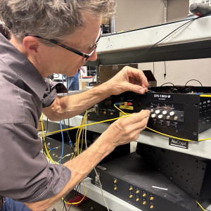 A man works on a quantum control box. 