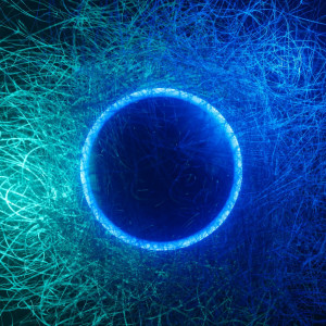 A glowing blue ring surrounded by a web of bright blue and teal lines on a dark blue background.
