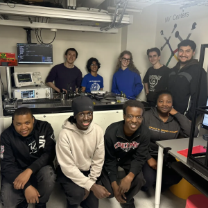 Students in quantum laboratory posing for picture