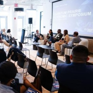 Four quantum industry leader panelists sit in front of an audience to discuss the tools necessary to build a successful quantum workforce.