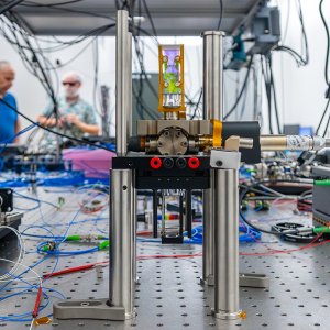 An ultra high vacuum glass cell manufactured by Infleqtion is pictured. Laser techniques cool and trap atoms inside the cell to provide an array of atomic qubits at the heart of the quantum computer.